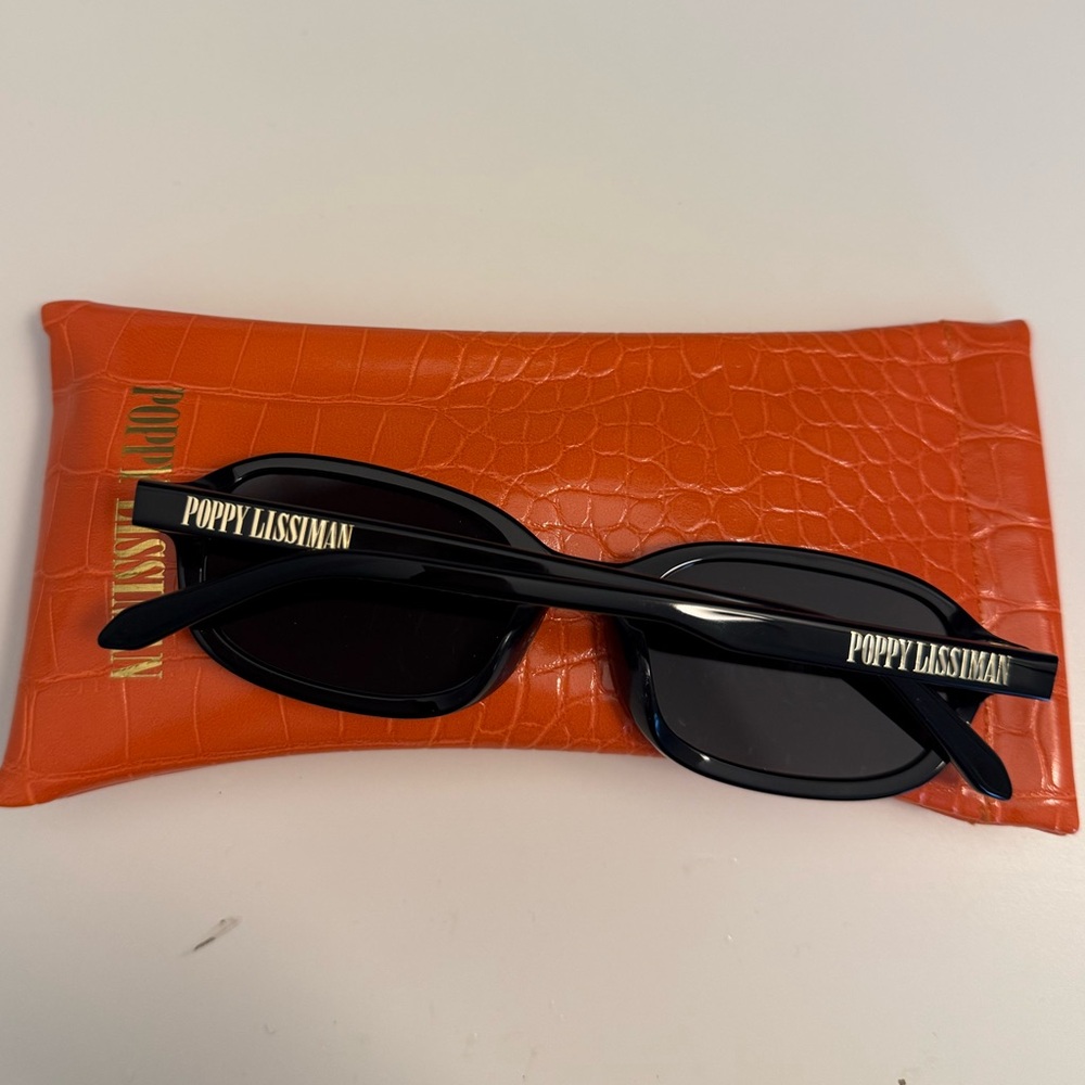 Poppy Lissiman Black Sunglasses with Orange Case